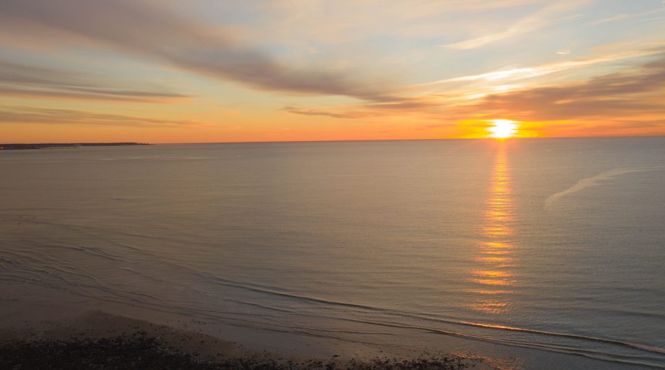Calm ocean horizon at sunrise